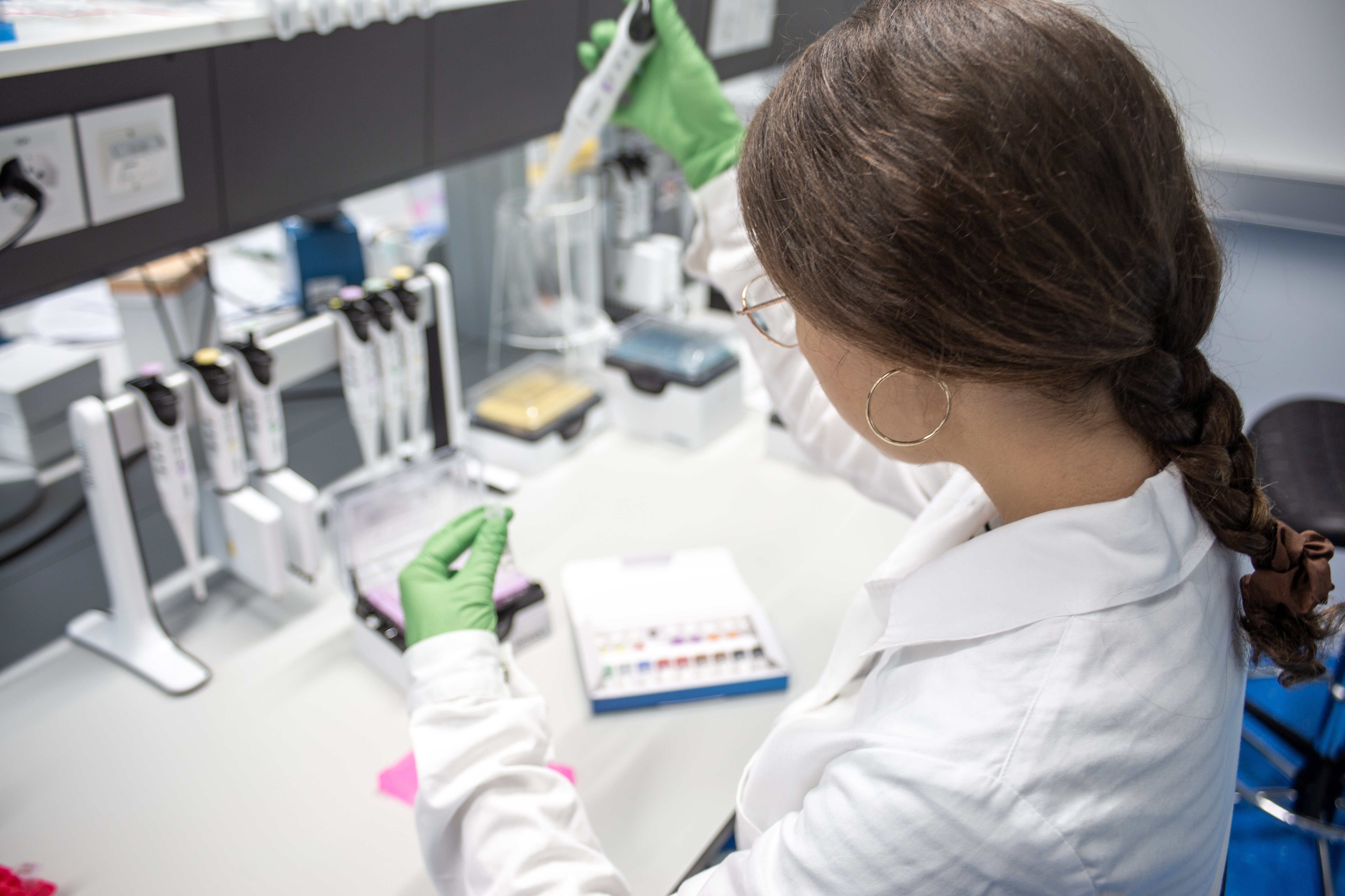 Woman holding pipette and test tube